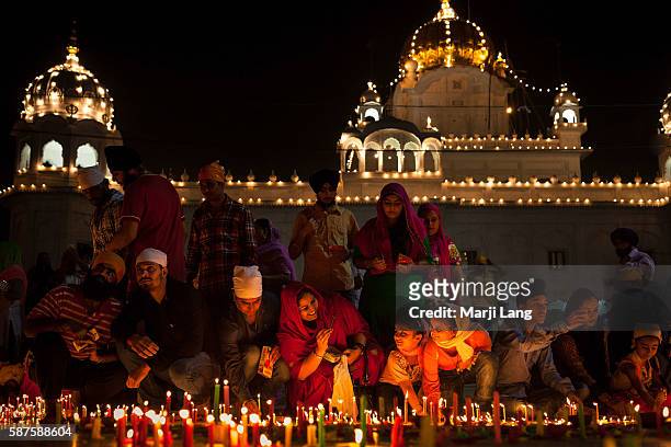 Crowd of Sikh devotees celebrating Diwali festival night, also Bandi Chhor Divas celebration for the Sikh religion followers at the Gurdwara Dukh...