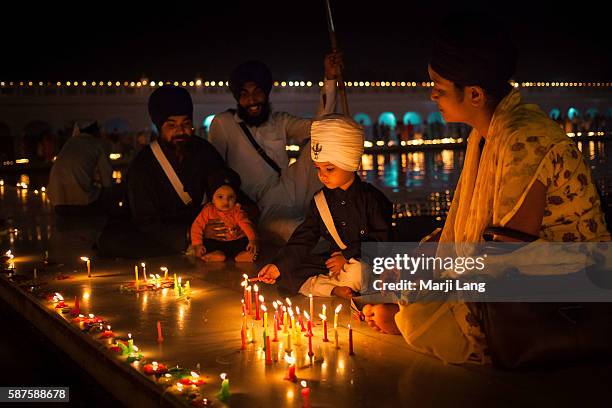 Sikh family celebrating Diwali festival night, also Bandi Chhor Divas celebration for the Sikh religion followers at the Gurdwara Dukh Nivaran Sahib...