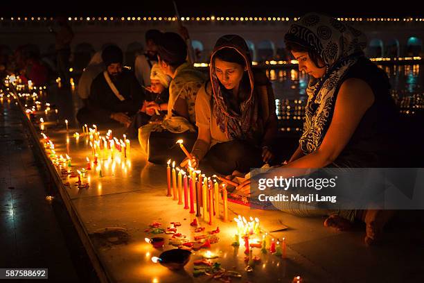 Sikh family celebrating Diwali festival night, also Bandi Chhor Divas celebration for the Sikh religion followers at the Gurdwara Dukh Nivaran Sahib...