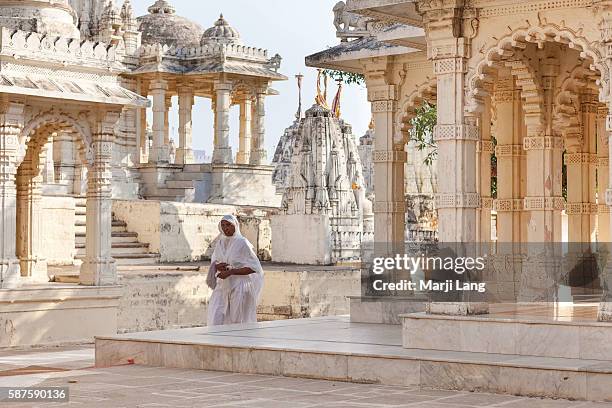 Jain nun walking in Palitana temples on Shatrunjaya hill, Gujarat, India.