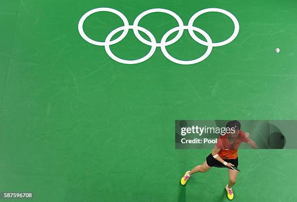 An overview shows Li Xiaoxia of China watching the ball as she celebrates a point against Cheng I-Ching of Taiwan in their women's singles...