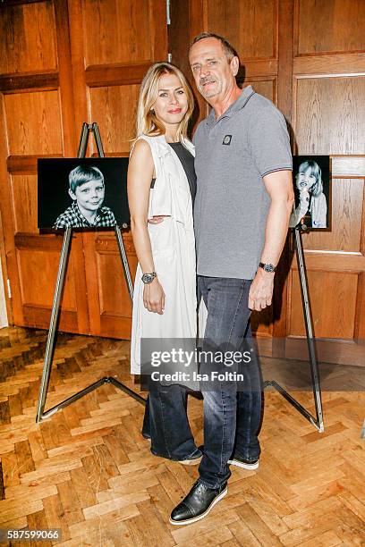 Goetz Elbertzhagen and his girlfriend Lydia Becker attend the photo exhibition 'Die Kunst des Kinderlaechelns' by Peter Badge on August 9, 2016 in...