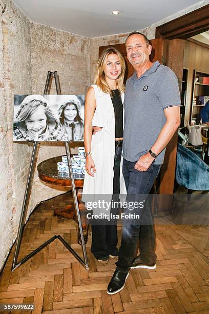 Goetz Elbertzhagen and his girlfriend Lydia Becker attend the photo exhibition 'Die Kunst des Kinderlaechelns' by Peter Badge on August 9, 2016 in...