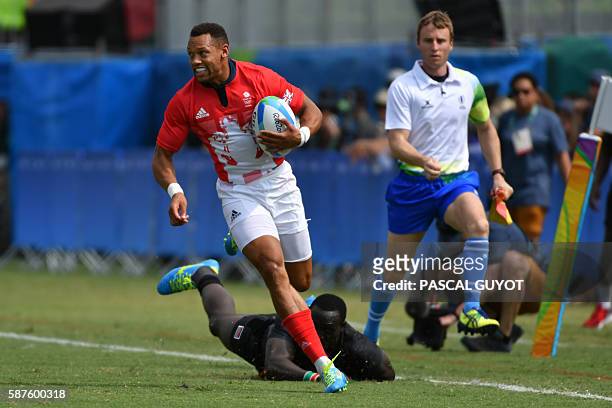 Britain's Dan Norton scores a try in the mens rugby sevens match between Britain and Kenya during the Rio 2016 Olympic Games at Deodoro Stadium in...