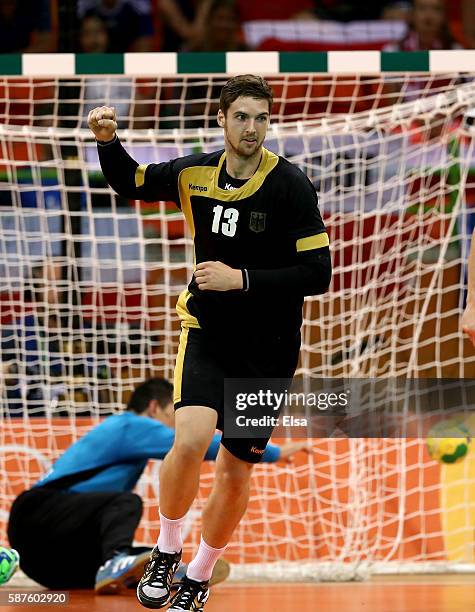 Hendrik Pekeler of Germany celebrates hit goal as Slawomir Szmal of Poland reacts in the first half on Day 4 of the Rio 2016 Olympic Games at the...