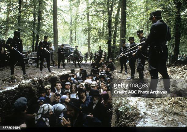 Miniseries - "The Changing of the Guard" - Airdate: February 11, 1983. NAZI SOLDIERS ABOVE CIVILIANS IN MASS GRAVE DURING MASSACRE AT MINSK