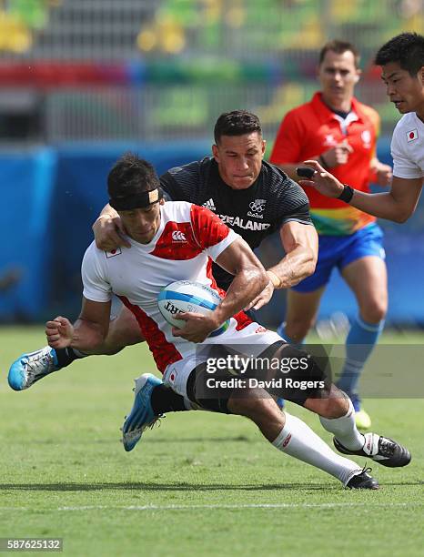 Yusaku Kuwazuru of Japan is tackled by Sonny Bill Williams of New Zealand during the Men's Rugby Sevens Pool C match between New Zealand and Japan on...