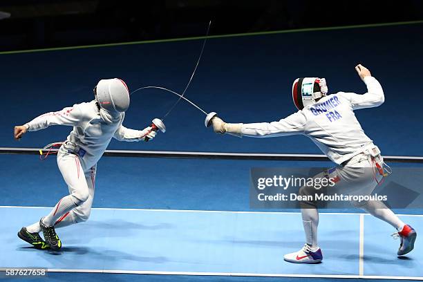 Kazuyasu Minobe of Japan in action against Gauthier Grumier of France during the quarterfinal in the Men's Epee Individual on Day 4 of the Rio 2016...