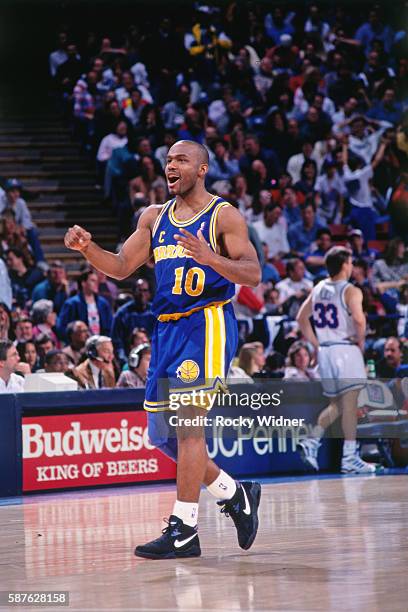 Circa 1992: Tim Hardaway of the Golden State Warriors celebrates during the game against the Sacramento Kings at the Alameda County Coliseum Arena in...