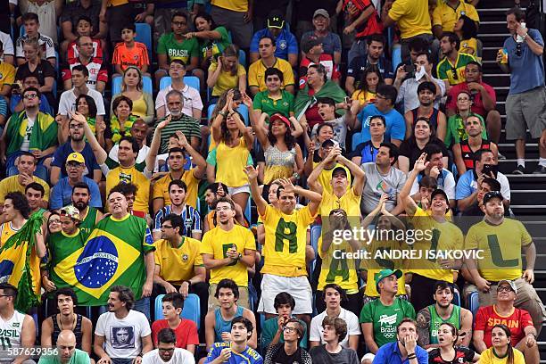 Brazil's fans cheer during a Men's round Group B basketball match between Spain and Brazil at the Carioca Arena 1 in Rio de Janeiro on August 9, 2016...