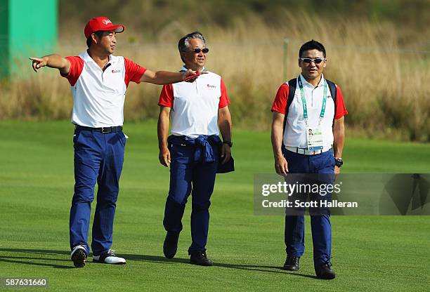 Yuta Ikeda of Japan walks with Massy Kuramoto and Shigeki Maruyama during a practice round on Day 4 of the Rio 2016 Olympic Games at Olympic Golf...