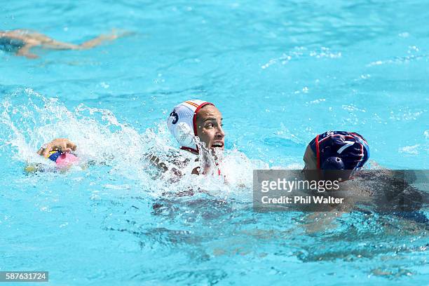 Anna Espar Llaquet of Spain prepares to pass the ball over Courtney Mathewson of United States during the Preliminary Round, Group B Womens Waterpolo...