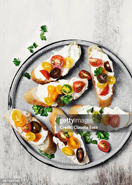 crostini with fresh tomatoes on a platter - crostini stock pictures, royalty-free photos & images