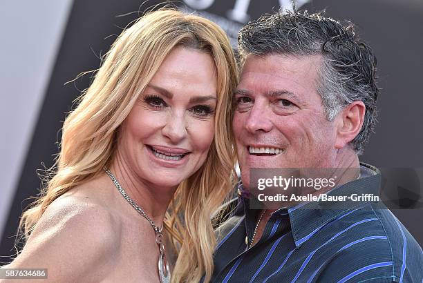 Personality Taylor Armstrong and husband John Bluher arrive at the premiere of STX Entertainment's 'Bad Moms' at Mann Village Theatre on July 26,...