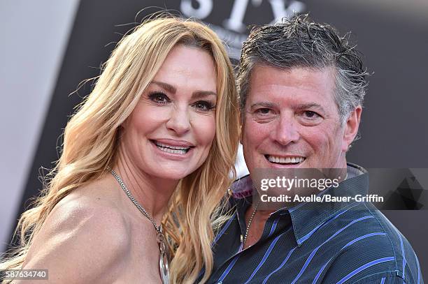 Personality Taylor Armstrong and husband John Bluher arrive at the premiere of STX Entertainment's 'Bad Moms' at Mann Village Theatre on July 26,...