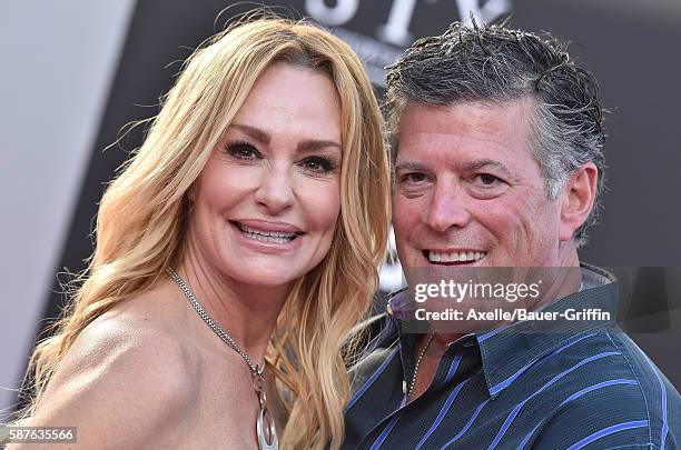 Personality Taylor Armstrong and husband John Bluher arrive at the premiere of STX Entertainment's 'Bad Moms' at Mann Village Theatre on July 26,...