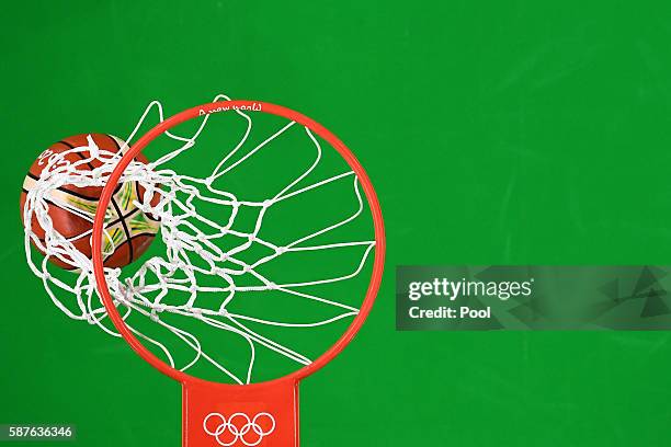 Detail view of the ball going through a hoop during a preliminary round basketball game between Spain and Brazil on Day 4 of the Rio 2016 Olympic...