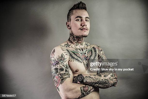 a young man with tattoos - tattoo designs for men chest stock pictures, royalty-free photos & images