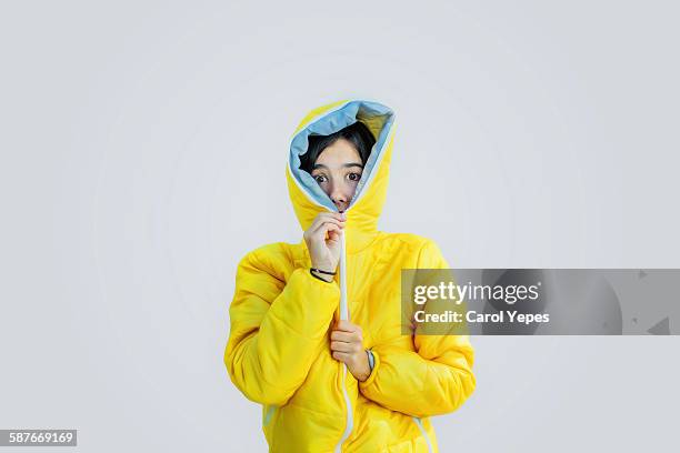 girl closing zipper of wooden jacket - yellow jacket stockfoto's en -beelden