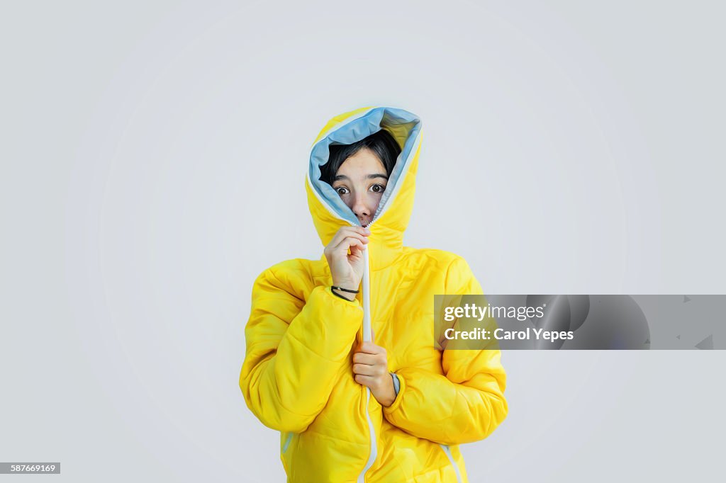 Girl closing zipper of wooden jacket