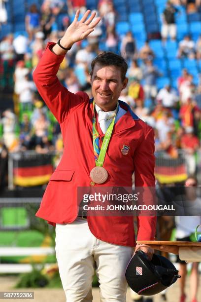 S Phillip Dutton waves from the podium after the Eventing's Jumping of the Equestrian during the 2016 Rio Olympic Games at the Olympic Equestrian...