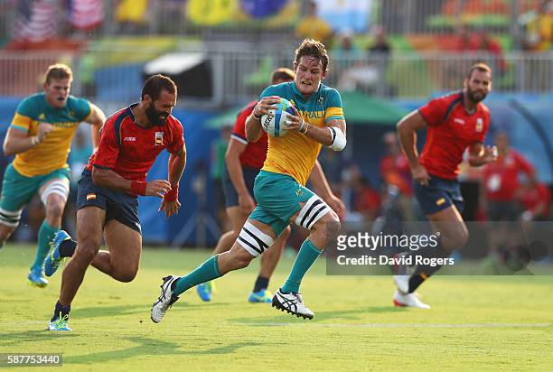 Con Foley of Australia breaks through to score a try during the Men's Rugby Sevens Pool B match between Australia and Spain on Day 4 of the Rio 2016...