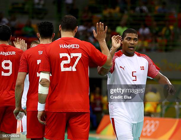 Aymen Hammed of Tunisia and Mads Mensah Larsen of Denmark greet each other after the match on Day 4 of the Rio 2016 Olympic Games at the Future Arena...