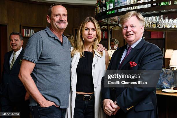 Goetz Elbertzhagen, Lydia Becker and Nikolaus Turner attend Photo exhibition 'Die Kunst des Kinderlaechelns' by Peter Badge on August 9, 2016 in...