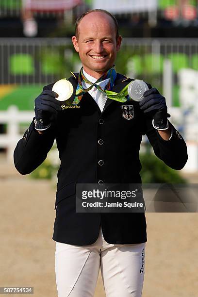 Gold medallist Michael Jung of Germany poses during the medal ceremony for the eventing Individual final on Day 4 of the Rio 2016 Olympic Games at...