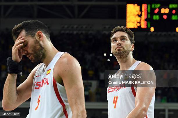 Spain's small forward Rudy Fernandez and Spain's centre Pau Gasol leave the court after Brazil defeated Spain during a Men's round Group B basketball...