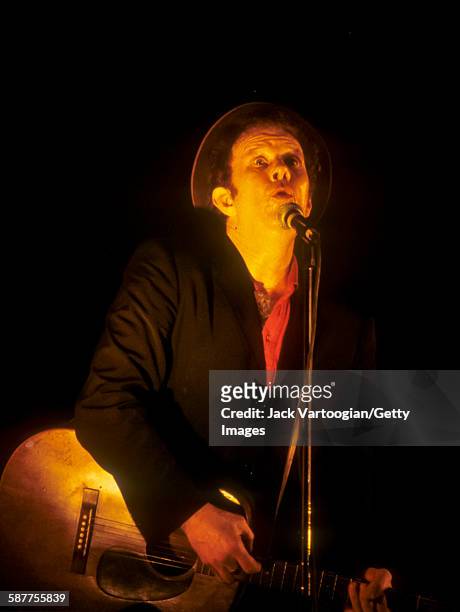American musician Tom Waits plays guitar as he performs at the Beacon Theater, New York, New York, September 23, 1999.