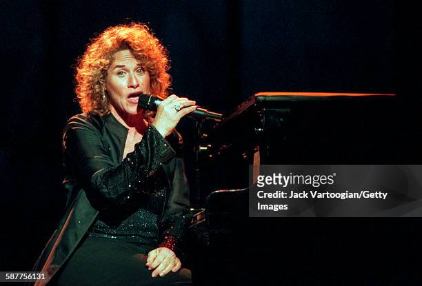 American Pop musician Carole King sits at the piano as she performs in the Theater at Madison Square Garden during People Magazine's 25th Anniversary...