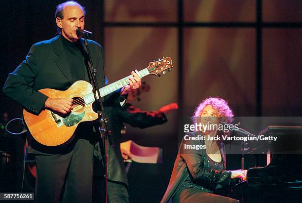 American Pop musicians James Taylor, on guitar, and Carole King, on piano, perform in the Theater at Madison Square Garden during People Magazine's...