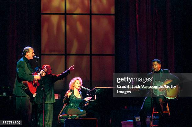 American Pop musicians James Taylor , on guitar, and Carole King, on piano, with R&B musician Babyface , also on guitar, perform in the Theater at...