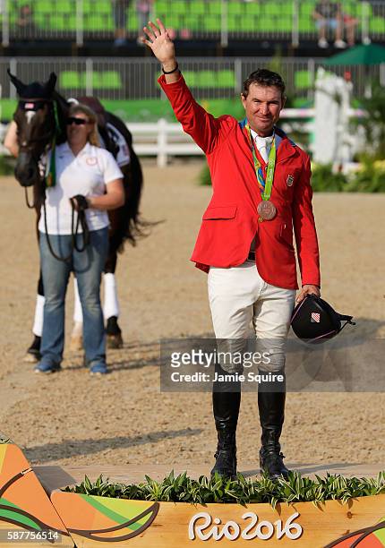 Bronze medallist Phillip Dutton of the United States pose during the medal ceremony for the eventing team Individual final on Day 4 of the Rio 2016...