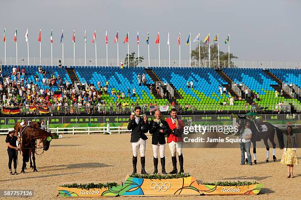 Silver medalist Astier Nicolas of France, Gold medal medallist Michael Jung of Germany and bronze medallist Phillip Dutton of the United States pose...