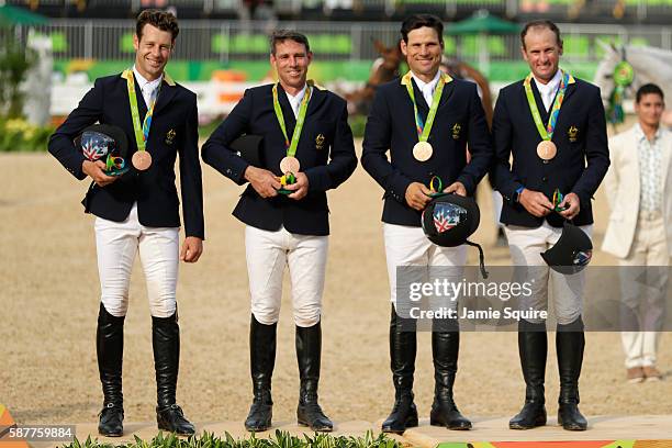 Bronze medallists Shane Rose, Stuart Tinney, Sam Griffiths and Christopher Burton of Australia pose during the medal ceremony for the eventing team...