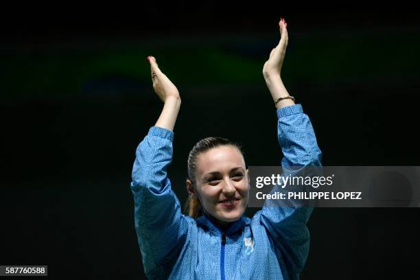 Gold medalist Greece's Anna Korakaki celebrates on the podium during the medal ceremony of the women's 25m pistol shooting event at the Rio 2016...