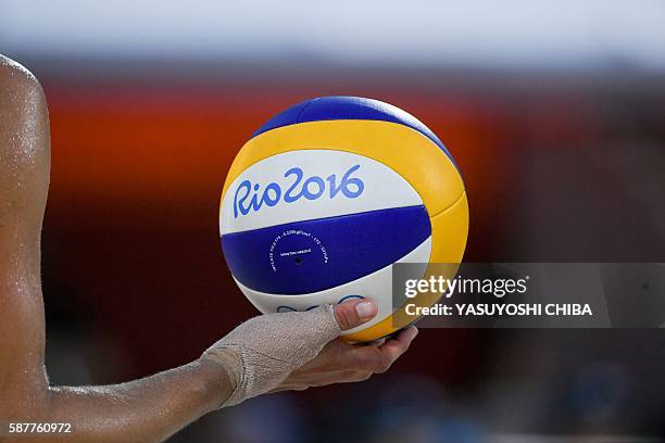 S Lauren Fendrick holds the ball during the women's beach volleyball qualifying match between Brazil and the USA at the Beach Volley Arena in Rio de...