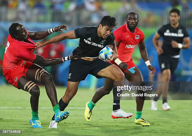 Rieko Ioane of New Zealand holds off Humphrey Kayange of Kenya during the Men's Rugby Sevens Pool C match between New Zealand and Kenya on Day 4 of...