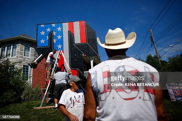 New York artist Scott LoBaido works on a 'Patriotic Lawn T' in support 2016 Republican presidential nominee Donald Trump in the area of Castleton...