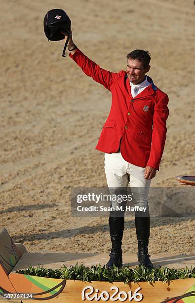 Bronze medallist Phillip Dutton of the United States pose during the medal ceremony for the eventing team Individual final on Day 4 of the Rio 2016...