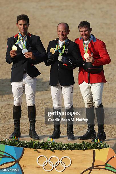 Silver medalist Astier Nicolas of France, Gold medal medallist Michael Jung of Germany and bronze medallist Phillip Dutton of the United States pose...