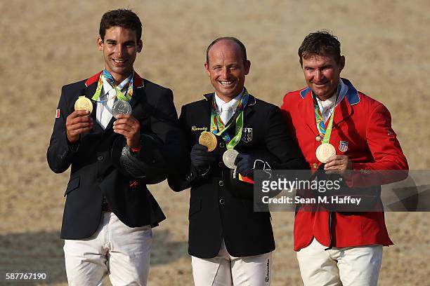 Silver medalist Astier Nicolas of France, Gold medal medallist Michael Jung of Germany and bronze medallist Phillip Dutton of the United States pose...