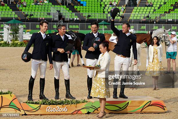 Bronze medallists Shane Rose, Stuart Tinney, Sam Griffiths and Christopher Burton of Australia pose during the medal ceremony for the eventing team...