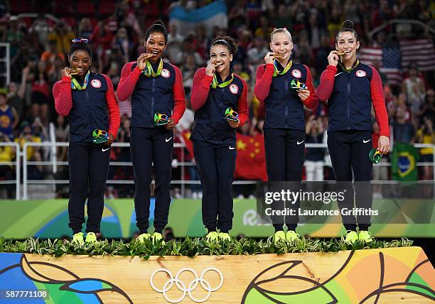 Gold Medalists Simone Biles, Gabrielle Douglas, Lauren Hernandez, Madison Kocian and Alexandra Raisman of the United States celebrate on the podium...