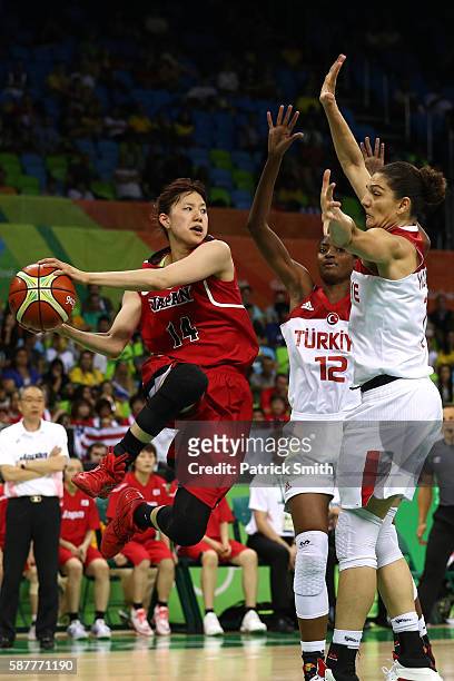 Sanae Motokawa of Japan looks to pass after dribbling past Lara Sanders of Turkey in the Women's Basketball Preliminary Round Group A match between...