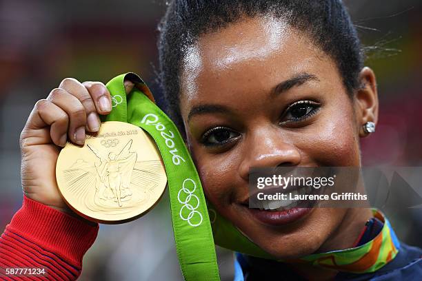 Gabrielle Douglas of the United States poses for photographs with her gold medal after the medal ceremony for the Artistic Gymnastics Women's Team on...