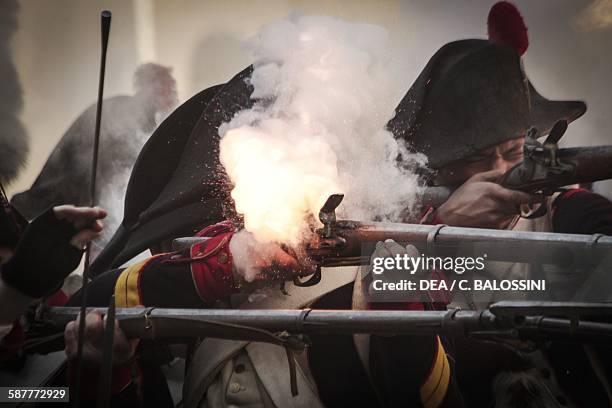 Soldiers of Napoleon's line infantry firing their weapons. Napoleonic wars, 19th century. Historical reenactment.