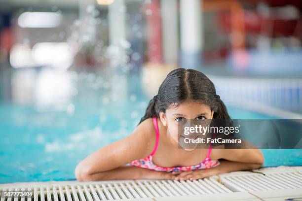 little girl taking swimming lessons - indian girls bath stock pictures, royalty-free photos & images
